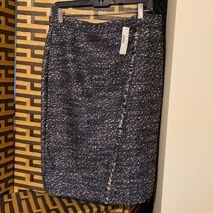 A pencil style NEW tweed black skirt with silver threads.